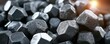 © Safar - Pile of faceted, metallic objects with a warm light glinting on the edges