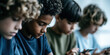 © Shelley - Focused Boys Engaged with Smartphones, Diverse Group in Casual Shirts, Blurred Background, Modern Technology Use