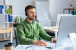 © Prostock-studio - Focused Caucasian Man Wearing Headset Working On Computer, Engaged In Task At Modern Office Environment. Professional Male In Adult Age Handling Work Responsibilities, Business Concept