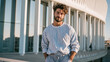 © Alive - Man stands outside modern building during sunset near city
