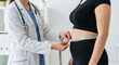 © Seen - Female Doctor Measuring Overweight Patient Waist with Tape in Clinic, Healthcare and Weight Management Concept