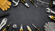© Wilden - Hand tools flat lay frame on dark stone background with copy space for hardware store template. copy space