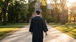 © Infinite Views - Graduate student in cap and gown walking on university campus path holding diploma, academic achievement and education success concept