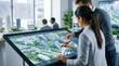 © Morgan - Architects and urban planners designing eco-smart city project on large digital display, discussing sustainable materials, green energy solutions