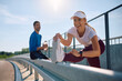 © Drazen - Happy athletic woman warming up for a run outdoors.
