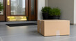 © Md Saiful - Cardboard package delivered to a modern home doorstep