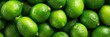 © Ilja - Vibrant Green Limes with Textured Skin on Bright Background, Ideal for Culinary Use and Decoration