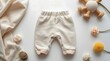 © Main - Cozy Baby Clothes and Toys on White Background.