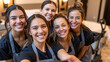 © Olga Ко - Close-up selfie of a cheerful team of young female hotel housekeepers in uniforms smiling in a guest room, hospitality and teamwork concept, AI generated