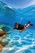 © Georgii - Scuba diver exploring clear tropical waters above a shallow shipwreck with diving gear and fins