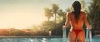 © Nikolay - Luxury summer vacation woman in red bikini at swimming pool back view with copy space