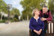 © BillionPhotos.com - Senior couple smiling and looking at each other on a park bench outdoors