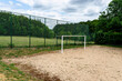 © Michal - Sand football pitch with goal and high fence