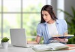 © BillionPhotos.com - Young woman studying with laptop and books at desk in bright home office