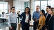 © Tep - A diverse group of business professionals standing in a modern office setting, discussing a project using a transparent board with a flowchart diagram.