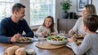 © SINGGIH - Happy Caucasian Family Eating Healthy Salad for Dinner at Home Together