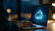 © Laura - Person working on a laptop with a cloud data and storage graphic displayed on screen during the night in a home office setting, cloud computing and remote work concept, faceless,