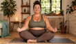 © thodonal - Woman practicing yoga and meditation in a cozy indoor space