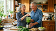 © ArtFocus Studio - Happy senior couple laughing while preparing a healthy green vegetable smoothie in their kitchen at home together.