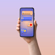 © New Africa - Woman holding mobile phone with open chat application against color gradient background, closeup. Messages on device screen