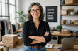 © Formoney - Business owner standing with arms crossed in small office