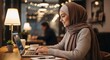 © mas - Professional Muslim Woman in Hijab Working on Laptop in Cafe
