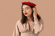 © Pixel-Shot - Beautiful young woman with red lips on brown background