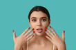 © Pixel-Shot - Surprised young woman with beautiful lips and stylish manicure on color background