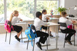 © Pixel-Shot - Little classmates sitting at desks in classroom during lesson