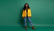 © Nana - Young woman in yellow jacket standing.