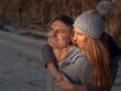© Bernd Bieder/imageBROKER - Intimate couple embracing, wearing winter clothes and bobble hat in nature, optimistic view to the horizon, trust in God's creation, Germany