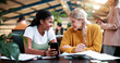 © peopleimages.com - Students, friends and education in college with phone for scholarship, exam score or curriculum. Happy women, university and together with mobile, upskill notification and talk for learning knowledge