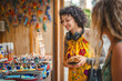 © Miljan Živković - Woman enjoying street market ceramic shopping and local crafts