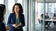 © Eve - Confident businesswoman talking to client in modern office hall. Corporate finance consultant, wealth manager, tax legal advisor, fintech communication and professional banking specialist.