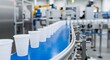 © MDSHAFIQ - Modern automated manufacturing line with plastic cups