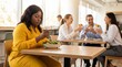 © Olga Ко - Sad isolated plus-size African American woman eating salad alone while slim colleagues socialize over burgers in office cafeteria, workplace exclusion and diet concept.