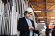 © dsheremeta - Mature man working on laptop in window factory