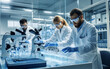© Valentyna - Three young adult scientists, two men and one woman, conduct collaborative research with microscopes and test tubes in a modern laboratory