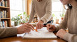 © Aurora Aesthetics - education mentorship tutoring student teacher learning guidance coaching support classroom adult learner receives patient help over workbook pages in bright study space with collaborative problem