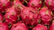 © Intan - A close-up shot of a vibrant pile of fresh dragon fruits, showcasing their distinctive pink skin and tropical allure, ready for a healthy and delicious snack