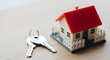© ANMZAKARIA - Toy house model with red roof and white fence | Silver keys for new home ownership | Real estate market and property investment | Mortgage loan symbol | Residential housing rental concept