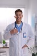 © New Africa - Portrait of medical assistant with stethoscope in clinic