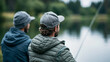 © Nataliya - Anonymous male friends or brothers fishing at a lake, outdoor hobby and active lifestyle concept, faceless, defocused nature background, with copy space