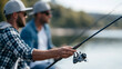 © Nataliya - Anonymous male friends or brothers fishing at a lake, outdoor hobby and active lifestyle concept, faceless, defocused nature background, with copy space