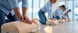 © keks20034 - Group cardiopulmonary resuscitation workshop showing man pressing on chest of medical dummy