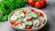 © Natali - Cucumber, cherry tomato, and red onion salad in a creamy herb dressing