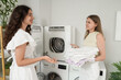 © Pixel-Shot - Female students doing laundry in dormitory