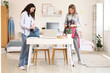 © Pixel-Shot - Female students packing backpacks in dorm room