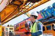 © JD Studio - Engineer inspecting crane machinery outdoor construction site