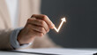© Nattapol - Hand holding glowing upward arrow over document, growth concept
